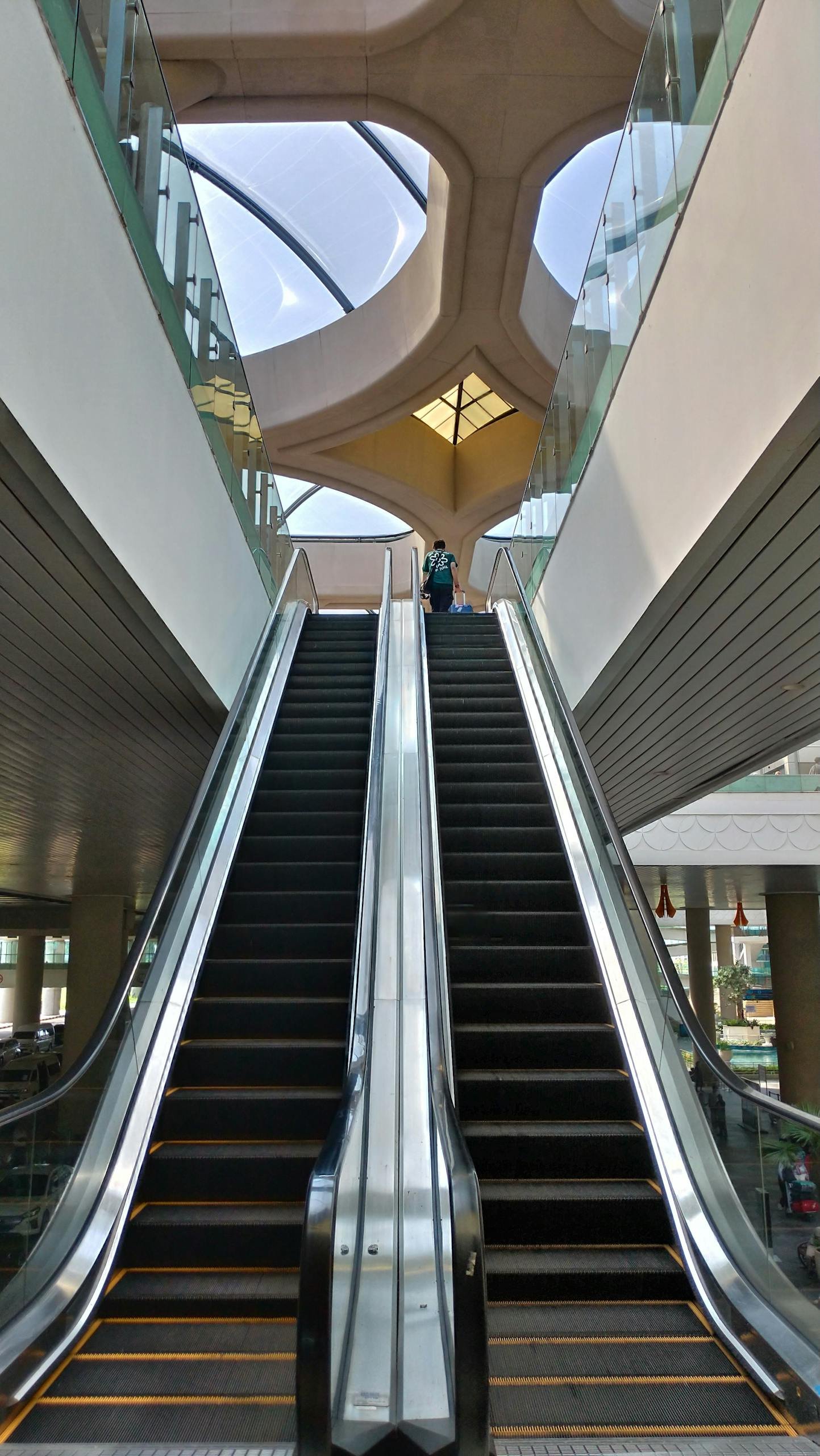 Vertical shot of contemporary escalators inside a Yogyakarta mall.